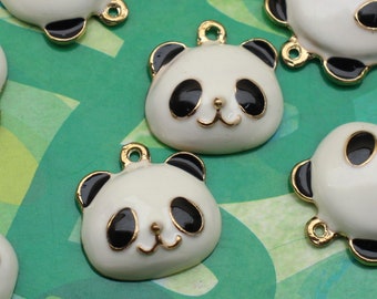 May include: A set of six white panda bear charms with black eyes and ears. The charms have a gold loop for attaching to jewelry or other crafts.