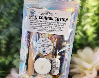 May include: A holographic pouch containing a Spirit Communication spell kit. The label lists contents including oil, a tealight, and a herb blend. Inside are a white tealight, a small glass vial of oil, a bag of dried herbs, and a silver feather charm.