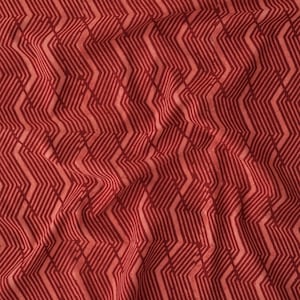 May include: Red fabric with a geometric pattern of thin, wavy lines. The fabric has a textured, woven look.