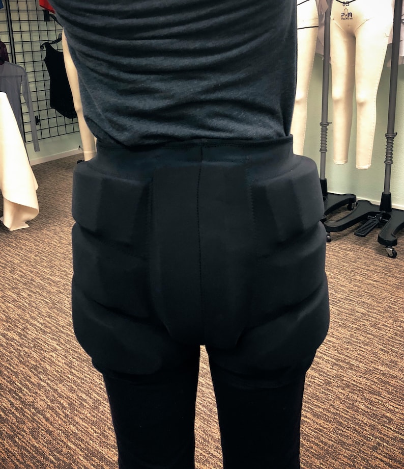 May include: Black padded leggings with a high waist and thick padding on the hips and thighs.