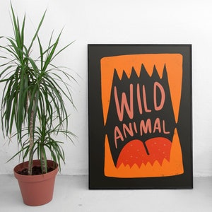 May include: Black and orange poster with the text "WILD ANIMAL" in pink and white lettering. The graphic features a large orange mouth with sharp teeth.