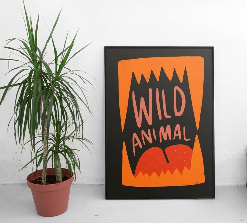May include: Black and orange poster with the text "WILD ANIMAL" in pink and white lettering. The graphic features a large orange mouth with sharp teeth.