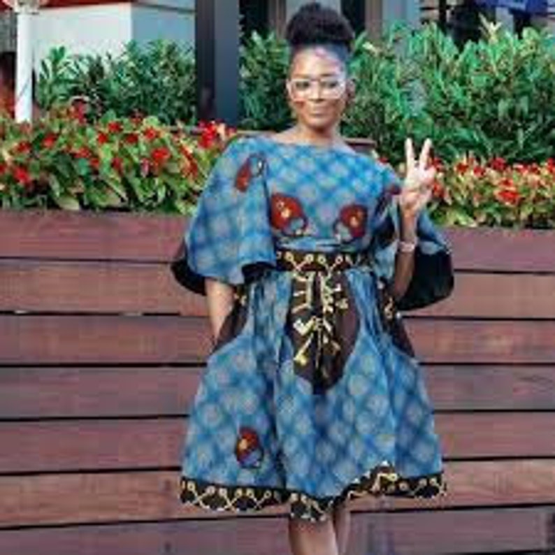 May include: A blue and black patterned dress with a short skirt and bell sleeves. The dress has a belt and pockets.