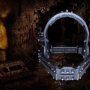 May include: A dark image featuring a metal head-worn device with spikes, reminiscent of a horror film prop. The background includes a creepy face with a spiral design on the cheek and the text "I WANT TO PLAY A GAME".