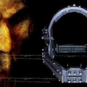 May include: A black metal head-worn device with multiple rivets and a hinged design, set against a black background. The image also features a close-up of a pale face with a spiral design on the cheek and a red eye.