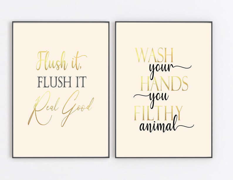 Puede incluir: Dos impresiones enmarcadas con letras doradas sobre un fondo crema. La primera impresi&oacute;n dice "Flush it. FLUSH IT Real Good". La segunda impresi&oacute;n dice "WASH your HANDS you FILTHY animal".