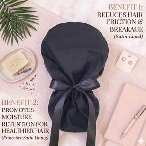 May include: A black satin-lined hair bonnet with a bow, designed to reduce friction and breakage. The image also shows a bar of shea butter soap, earrings, and a notebook. Text on the image reads: Reduces hair friction & breakage, promotes moisture retention.