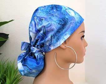 May include: Blue and white patterned surgical scrub hat with a tie at the back. The hat is made of a soft, comfortable fabric and is perfect for nurses, doctors, and other healthcare professionals.