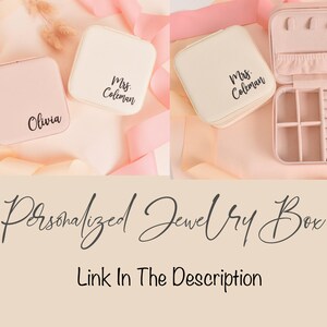 May include: Two personalized jewelry boxes with lids open. One box is pink and says "Olivia" on the lid. The other box is cream and says "Mrs. Coleman" on the lid. The cream box has a compartment for rings and earrings.