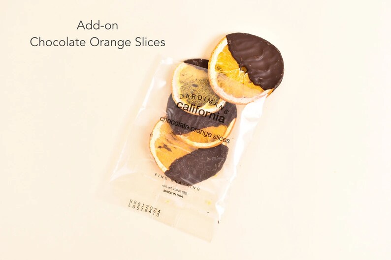 May include: A clear plastic bag filled with chocolate covered orange slices. The bag is labeled "Dardiman's California chocolate orange slices".