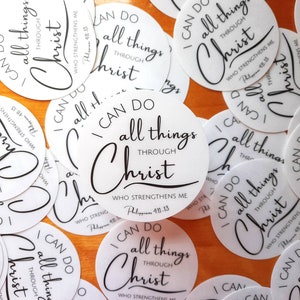 May include: A collection of white round stickers with black text that reads "I can do all things through Christ who strengthens me. Philippians 4:11-13".