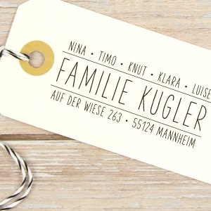 Pu&ograve; includere: Etichetta bianca con testo nero che dice "NINA. TIMO. KNUT. KLARA. LUISE. FAMILIE KUGLER. AUF DER WIESE 263. 55124 MANNHEIM".