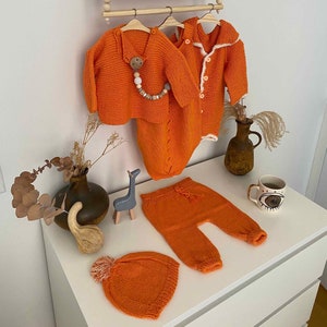 Baby romper, sweater, cardigan, pants and beanie set