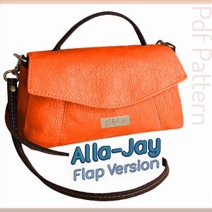 May include: Orange leather handbag with a flap closure and a black strap. The bag has a top handle and a long shoulder strap. The bag has the text "Alla-Jay Flap Version" printed on the front.