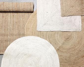May include: Four natural fiber rugs in various shapes and sizes. A round white rug, a round brown rug, a square white rug, and a rectangular brown rug.