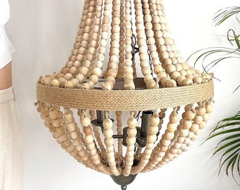 May include: A large, round, wooden bead chandelier with a jute rope trim. The chandelier has a rustic, farmhouse style and is perfect for adding a touch of warmth and elegance to any room.