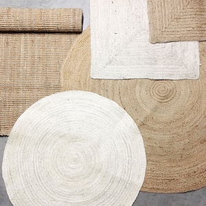 May include: A set of four jute rugs in various shapes and sizes. The rugs are made of natural jute fibers and have a woven texture. The rugs are in shades of beige and white.