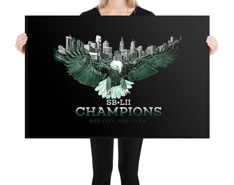 May include: A black and green poster with a silhouette of the Philadelphia skyline and a green eagle with its wings spread. The text "SB LII CHAMPIONS ONE CITY, ONE TEAM." is printed below the eagle.