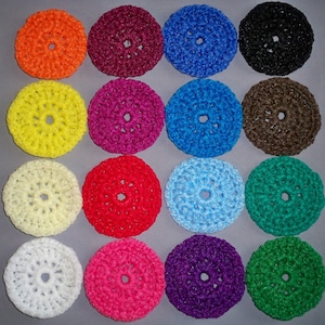 May include: Assortment of 15 crocheted hair scrunchies in various colors, including white, black, red, blue, green, yellow, brown, and purple.