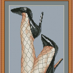 May include: A cross-stitch pattern of a pair of legs in fishnet stockings and high heels. The pattern is framed in a brown wooden frame.