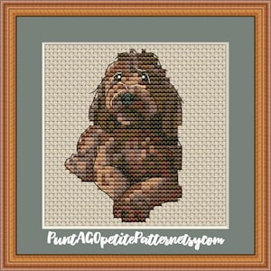 May include: Cross stitch pattern of a brown and black dog with a white background. The pattern is titled "Petite Pattern" and includes the website "PuntAGOpetitePatternetsy.com".