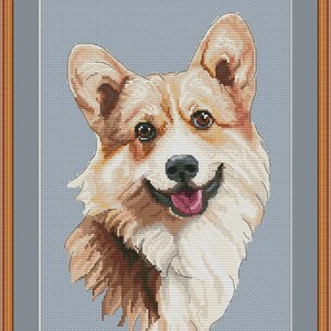 May include: Cross stitch pattern of a smiling corgi dog with brown and white fur. The dog is looking directly at the viewer with its tongue sticking out. The background is a light blue color.