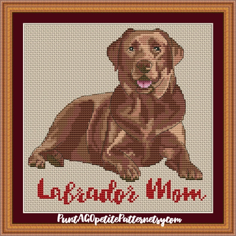May include: Cross stitch pattern of a brown Labrador Retriever dog sitting with the text "Labrador's Mom" in red.