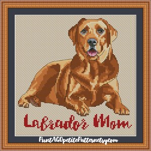May include: Cross stitch pattern of a brown Labrador Retriever dog sitting with the text "Labrador's Mom" in red.