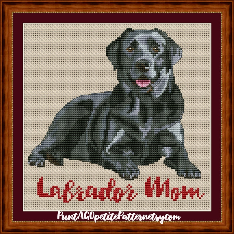 May include: Cross stitch pattern of a black Labrador Retriever sitting with the text "Labrador's Mom" below. The pattern is available for purchase from PuntAGOpatitePatternsEtsy.com.