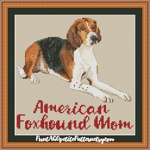 May include: Cross-stitch pattern of an American Foxhound dog lying down. The pattern is in shades of brown, black, and white. The text "American Foxhound Worm" is below the dog. The text "PuntAGOpetitePatternetsy.com" is below the text.