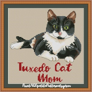 May include: Cross stitch pattern of a black and white tuxedo cat with green eyes. The cat is lying down and looking at the viewer. The text "Tuxedo Cat Mom" is below the cat.