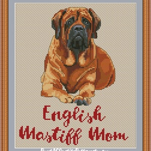 May include: Cross stitch pattern of an English Mastiff puppy sitting. The pattern is in red and white with the text "English Mastiff Mom" and the website "PuntAGOpetitePatternsetsy.com".