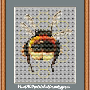 May include: Cross stitch pattern of a bumblebee with yellow, black, and orange stripes, with wings spread, on a honeycomb background. The pattern is titled "PuntAGOpetitePatternetsy.com".