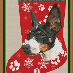 May include: A red Christmas stocking with a white paw print and snowflake pattern. A Rat Terrier dog's head peeks out of the stocking. The stocking has the text "Rat Terrier" at the top.