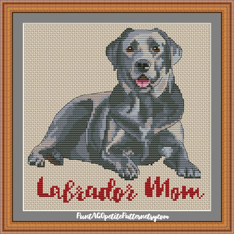 May include: Cross stitch pattern of a black Labrador Retriever dog sitting with its tongue sticking out. The pattern is titled "Labrador's Mom".