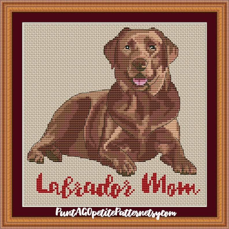 May include: Cross-stitch pattern of a brown Labrador Retriever dog sitting with the text "Labrador's Mom" in red.