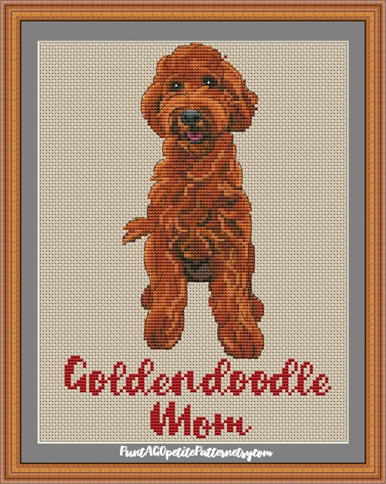 May include: Cross stitch pattern of a red golden doodle dog with the text "Golden doodle Mom" below.