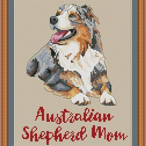 May include: Cross-stitch pattern of an Australian Shepherd dog with blue merle coloring, sitting with its head turned to the side. The pattern is titled "Australian Shepherd Mom" and includes the website "PuntAGOpettiePatternetsy.com".