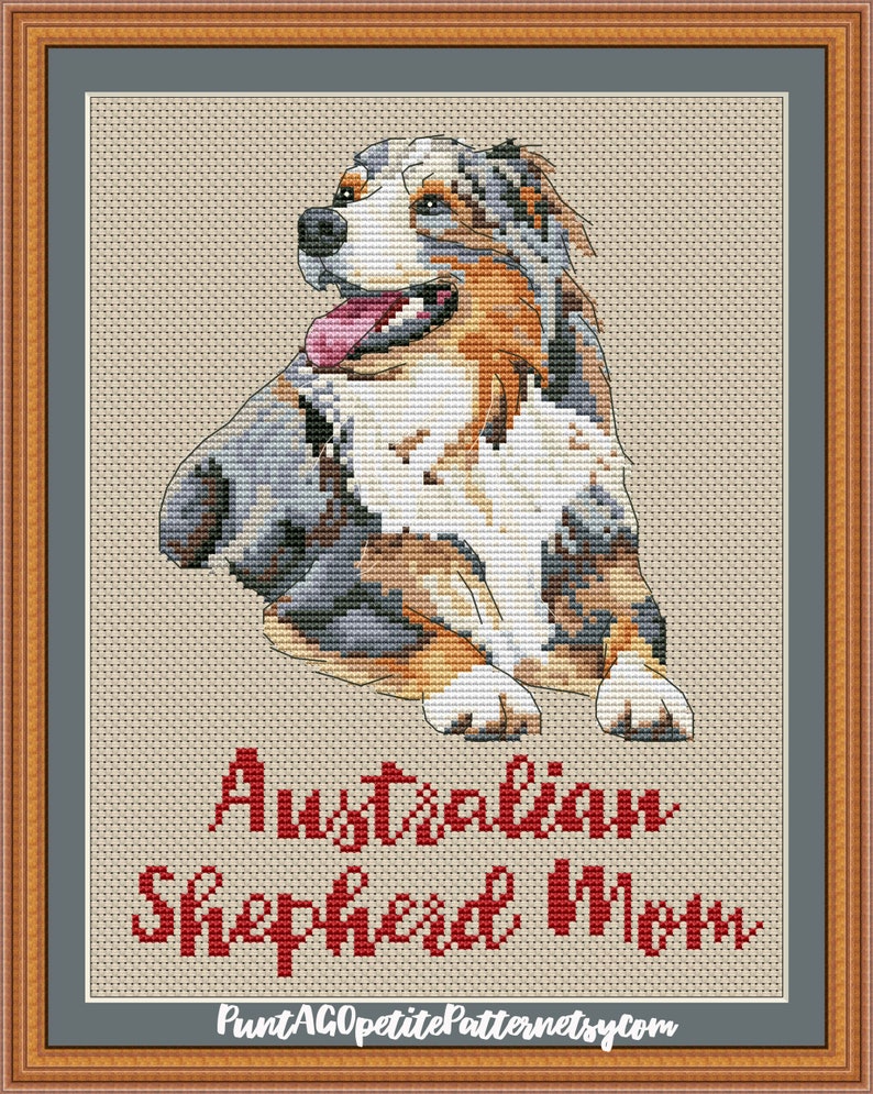 May include: Cross-stitch pattern of an Australian Shepherd dog with blue merle coloring, sitting with its head turned to the side. The pattern is titled "Australian Shepherd Mom" and includes the website "PuntAGOpettiePatternetsy.com".