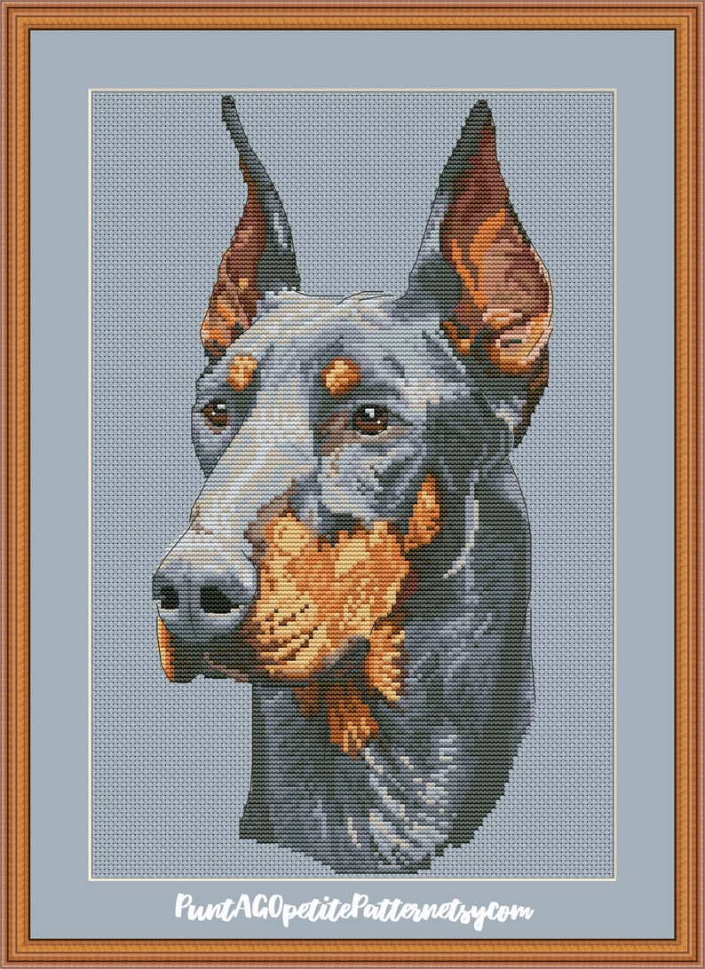 May include: A cross-stitch pattern of a Doberman Pinscher dog with black and tan fur. The dog is looking to the left of the image with its ears perked up.
