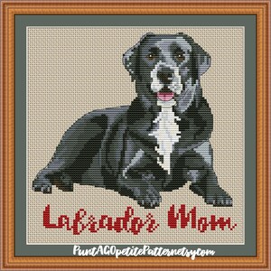 May include: Cross stitch pattern of a black and white dog with the text "Labrador's Mom" in red.