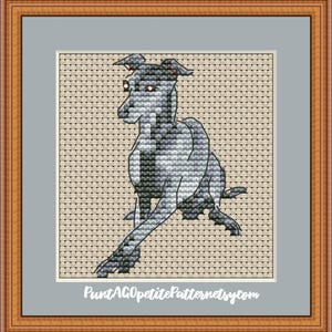 Puede incluir: Arte de punto de cruz de un galgo en tonos grises, negros y blancos. El perro est&aacute; representado en posici&oacute;n sentada, con las patas extendidas. La obra est&aacute; enmarcada en un marco de madera con un passe-partout gris.