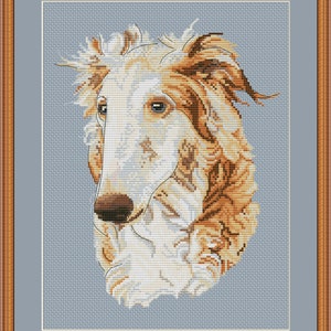 May include: Cross stitch pattern of a white and brown Borzoi dog with a blue background. The pattern is available for download on PetitePatternEtsy.com.