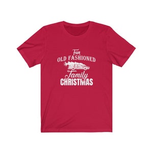 May include: Red t-shirt with a white graphic of a car with a Christmas tree on top. The text reads "Fun Old Fashioned Family Christmas".