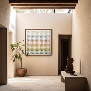 May include: A modern hallway with a light brown tiled floor, a potted plant, and a framed artwork with a colorful geometric pattern. The artwork is hanging on a light beige wall. A wooden bench with a stone sculpture and bowls sits on the right side of the hallway.