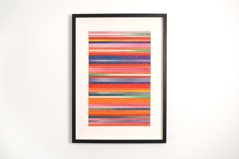 May include: A framed abstract art print with a colorful horizontal stripe pattern in shades of red, orange, yellow, green, blue, and purple.