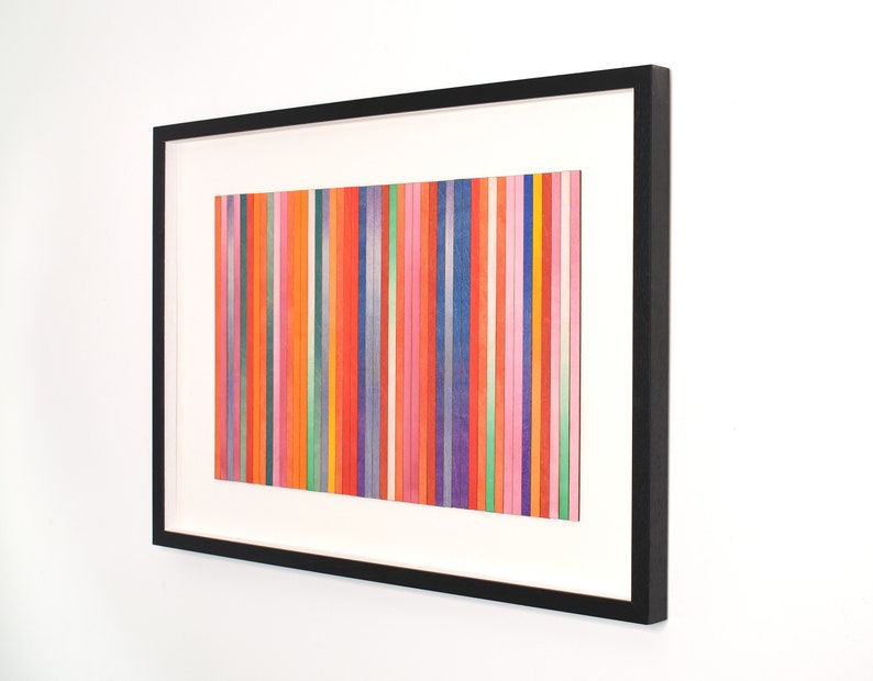 May include: Abstract art print with a framed image of vertical stripes in various colors, including red, orange, yellow, green, blue, purple, and pink.