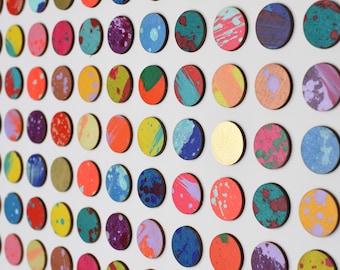 May include: A wall art piece featuring a grid of colorful circles with abstract paint splatters and brushstrokes. The circles are arranged in a repeating pattern, creating a visually stimulating and modern design.