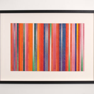 May include: A framed artwork featuring a colorful abstract design. The artwork is made up of vertical stripes of various colors, including red, orange, yellow, green, blue, purple, and pink.