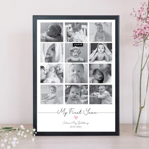 May include: A black framed photo collage with twelve black and white baby pictures. The words "My First Year" are written in cursive, with a pink heart. The baby's name and date are below the text.